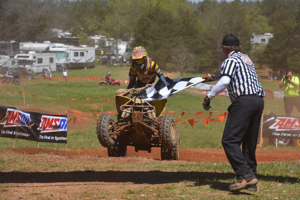 Hunter Hart, rider no. 211, grabs the checkers at an earlier round of GNCC Racing this year. Hart will be competing on both ATVs and motorcycles this weekend at the inaugural Tomahawk GNCC in Odessa, New York.