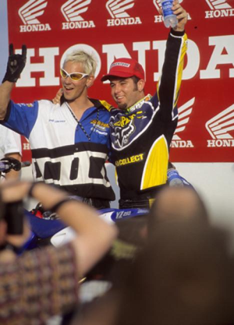 Lots of nineties in this pic: goatee, earrings, 1-800-collect, yellow lens sunglasses, bleached hair, Bridgestone tires, and no energy drink on the podium.