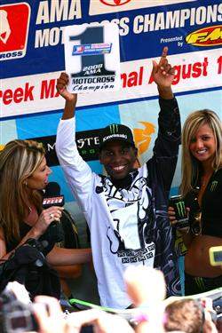 Stewart holds up his first AMA Motocross number one plate.
