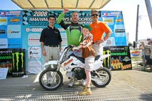 (Above) Monongahela's Ben Roberts poses on the new dirt bike he won at the American Motocross Festival, held last weekend at Steel City Raceway. The Kawasaki KLX110 was presented by Trib Total Media and the Pittsburgh Tribune Review, as well as Mosites Motorsports. Also pictured (from left to right) are: The Pittsburgh Tribune Review's Bill Fischer, Roberts' father, Rick, and Doug Mosites from Mosites Motorsports.