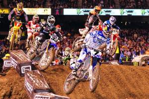 James Stewart (7) grabbed the holeshot in the 450cc main, followed by Josh Grant (33), Chad Reed (1) and the rest of the field.
