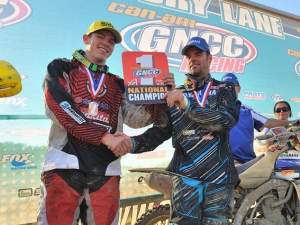 Paul Whibley, last year's GNCC Champ, hands the number-one plate over to Josh Strang.