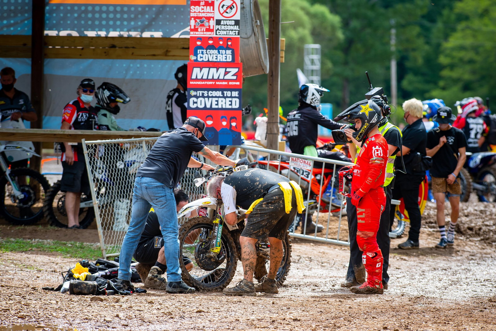 Zach Osborne watches as the Rockstar Energy Husqvarna team works on his Husqvarna FC 450 during the 450 Class A qualifying session. Osborne's bike would not fire during the only A qualifying session of the day.